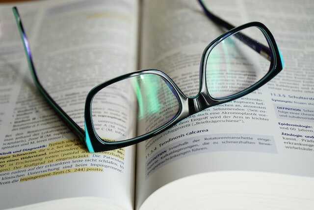 Eyeglasses With Black Frames on Book